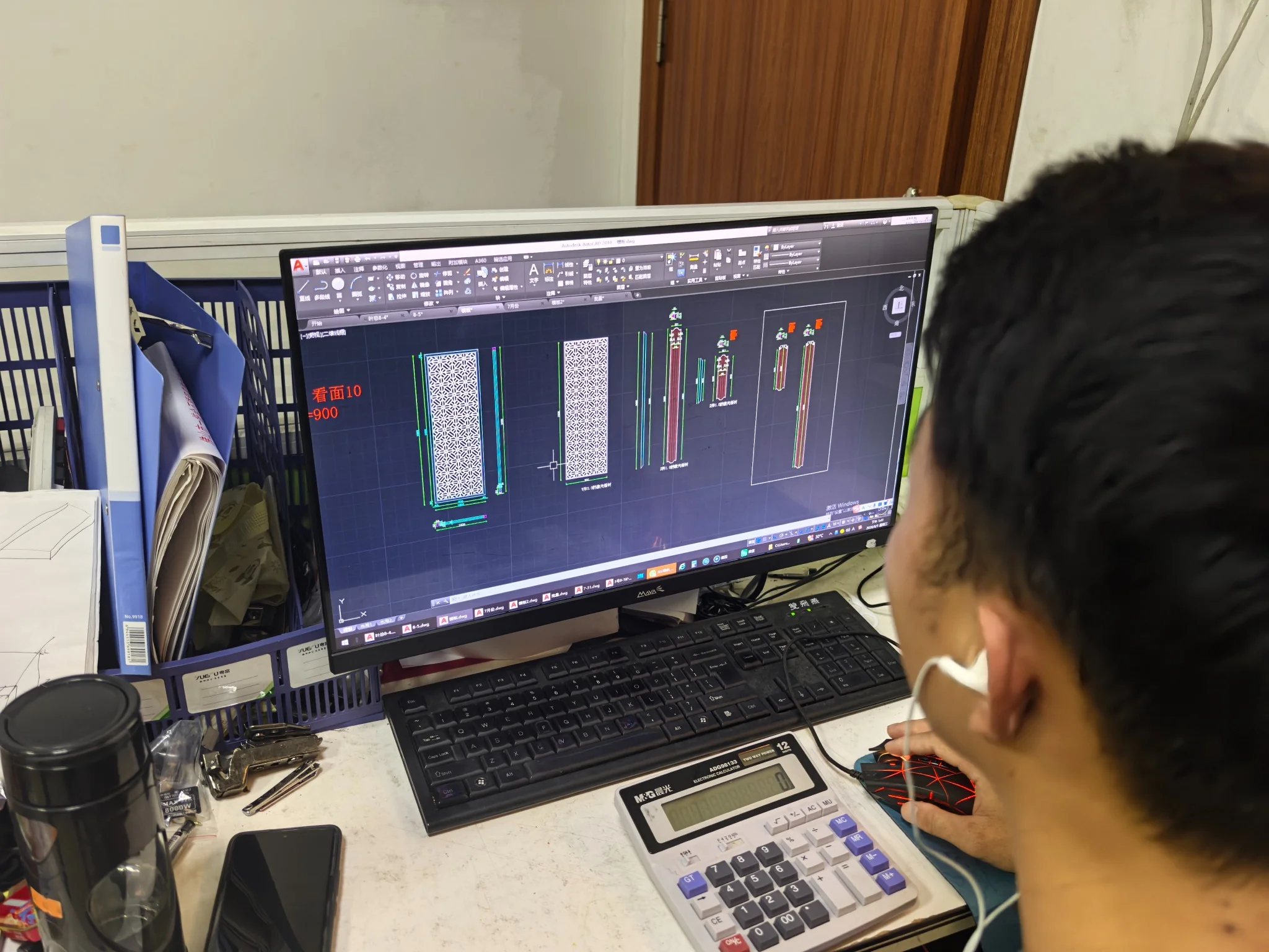 Designer reviewing stainless steel screen CAD drawing