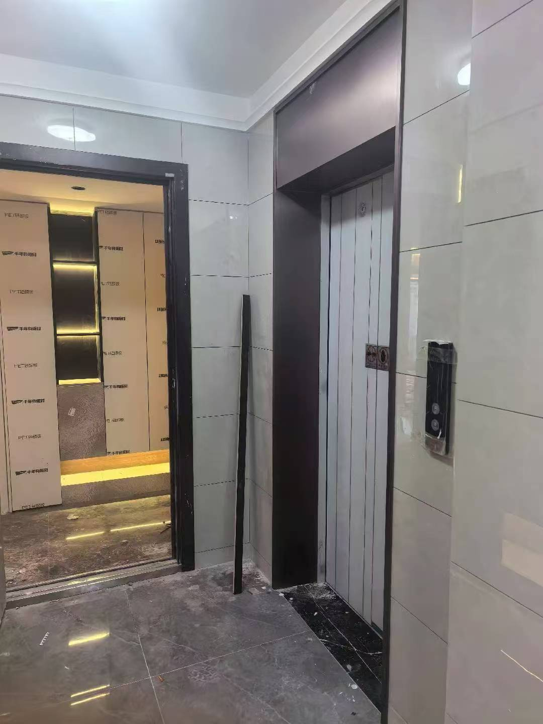 Installed black elevator entrance cladding